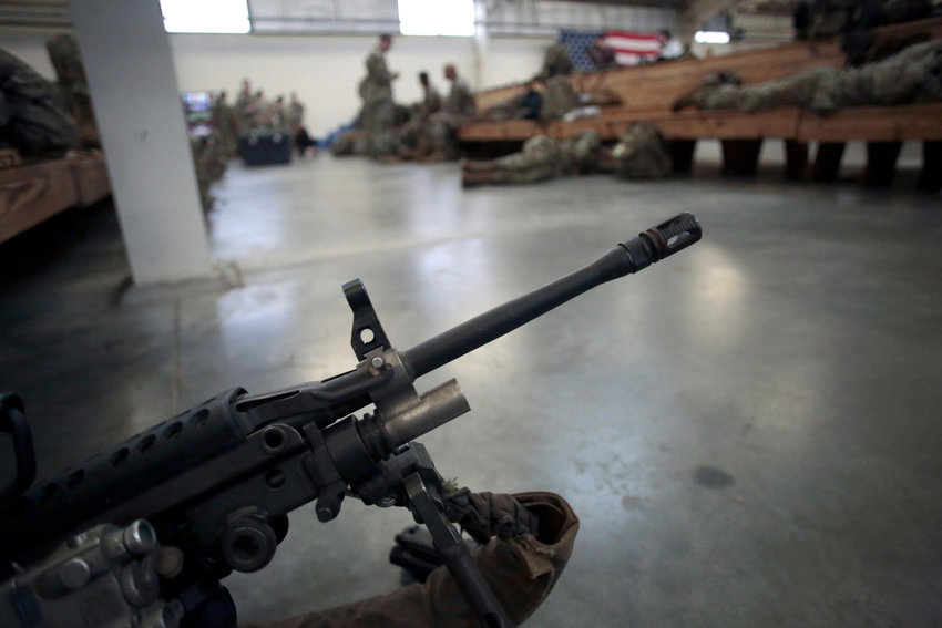 FILE - A U.S. Army soldier's weapon is shown, Jan. 4, 2020, at Fort Bragg, North Carolina. Two men who forged deep bonds of friendship while serving in the Army in Afghanistan would be arrested in 2018 for a scheme to steal weapons and explosives from an armory at Fort Bragg, North Carolina, and sell them. An Associated Press investigation into lost and stolen military weapons has shown that insider thefts remain a serious concern. (AP Photo/Chris Seward, File)