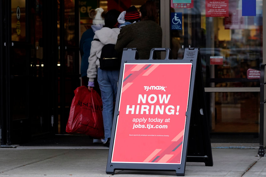 FILE - Hiring sign is displayed outside of a retail store in Vernon Hills, Ill., Saturday, Nov. 13, 2021.  On Thursday, Dec. 16, the number of Americans applying for unemployment benefits rose last week despite signs that the U.S. labor market is rebounding from last year&rsquo;s coronavirus recession.  (AP Photo/Nam Y. Huh, File)