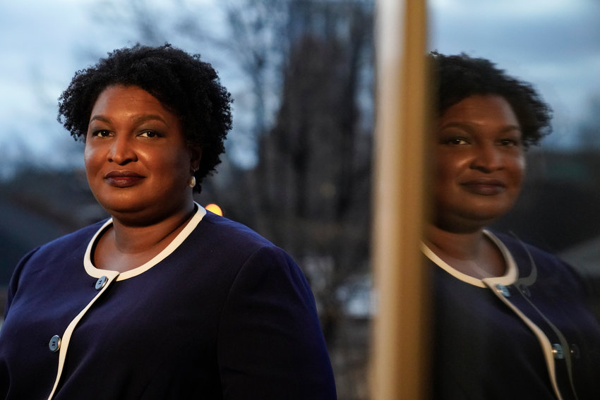 Georgia gubernatorial Democratic candidate Stacey Abrams poses for a photo during an interview with The Associated Press on Thursday, Dec. 16, 2021, in Decatur, Ga. Abrams is calling on Congress to act on voting rights as the Democrat launches a second bid to become her state's governor.  (AP Photo/Brynn Anderson)