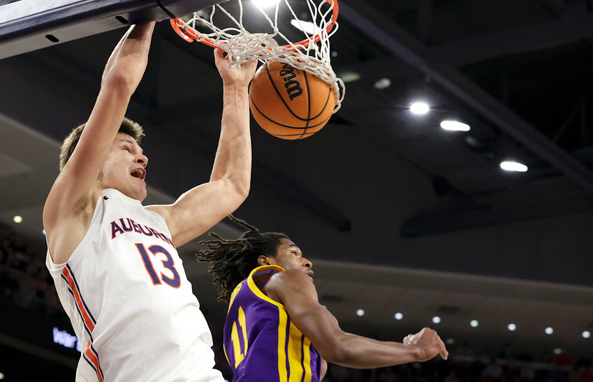 Auburn forward Walker Kessler (13) slam dunks the ball over LSU guard Justice Williams (11) during the second half of their game Wednesday at Auburn Arena.