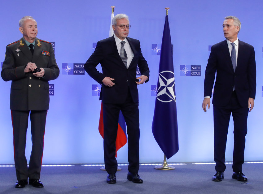 NATO Secretary General Jens Stoltenberg, right, welcomes Russia's Deputy Foreign Minister Alexander Grushko, center, and Russia's Deputy Defense Minister Alexander Fomin prior to the NATO-Russia Council at NATO headquarters, in Brussels, Wednesday, Jan. 12, 2022. Senior NATO and Russian officials are meeting Wednesday to try to bridge seemingly irreconcilable differences over the future of Ukraine, amid deep skepticism that Russian President Vladimir Putin's security proposals for easing tensions are genuine. (Olivier Hoslet, Pool Photo via AP)