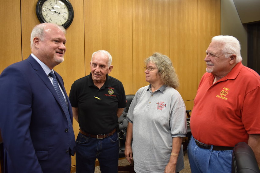 District 1 County Commission Keith Davis, far left, talks with Curry Volunteer Fire Department members in July 2021 after the commission voted to use legislative funds for a new shelter next to the Curry Fire Station. Shown are, from left volunteer Bruce Bennett, officer and EMS lieutenant Becky Atkins and board chairman Joe Batton.