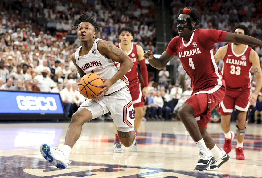 Auburn guard Wendell Green Jr. (1) drives to the basket on a fast break as Alabama forward Juwan Gary (4) defends during the second half of an NCAA college basketball game Tuesday, Feb. 1, 2022, in Auburn, Ala. (AP Photo/Butch Dill)