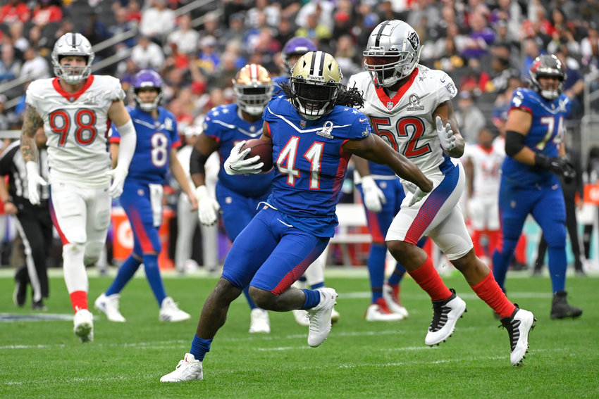 NFC running back Alvin Kamara of the New Orleans Saints (41) rushes as AFC inside linebacker Denzel Perryman of the Las Vegas Raiders (52) closes in during the first half of the Pro Bowl NFL football game, Sunday, Feb. 6, 2022, in Las Vegas. (AP Photo/David Becker)