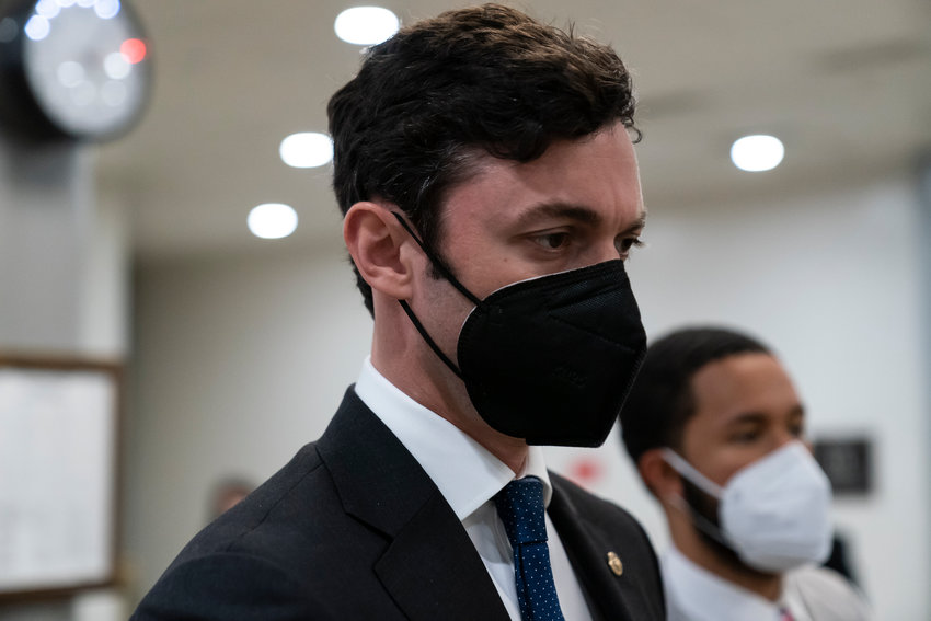 FILE - Sen. Jon Ossoff, D-Ga., walks on Capitol Hill, on Oct. 7, 2021, in Washington. Pressure is building for Congress to pass legislation that would curtail lawmakers' ability to speculate on the stock market. Public anger over congressional stock trading has mounted since the first tremors of the pandemic. (AP Photo/Alex Brandon, File)