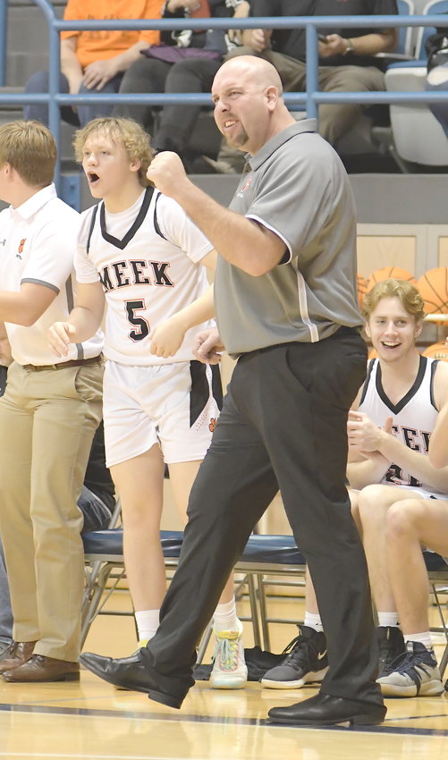 Meek basketball coach Bryan Woods and Braxton Dickerson (5) cheer on the Tigers during a game against Covenant Christian in the Northwest Regional Tournament at Wallace State-Hanceville in February. Woods is the Eagle Elite Boys Coach of the Year.