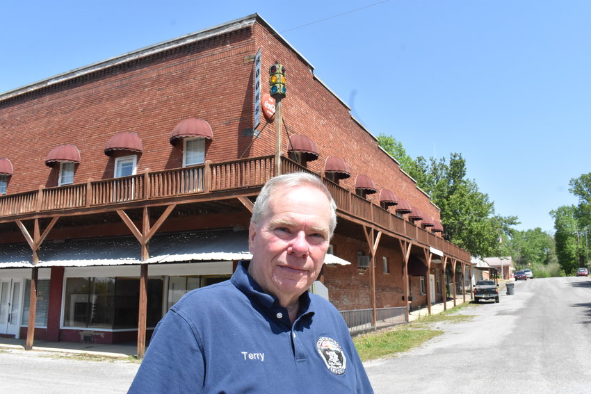 Nauvoo Mayor Terry Burgett stands in front of the old Harbin Hotel, which was constructed 99 years ago. Burgett said he and the Nauvoo Town Council are looking at a number of improvements for the town.
