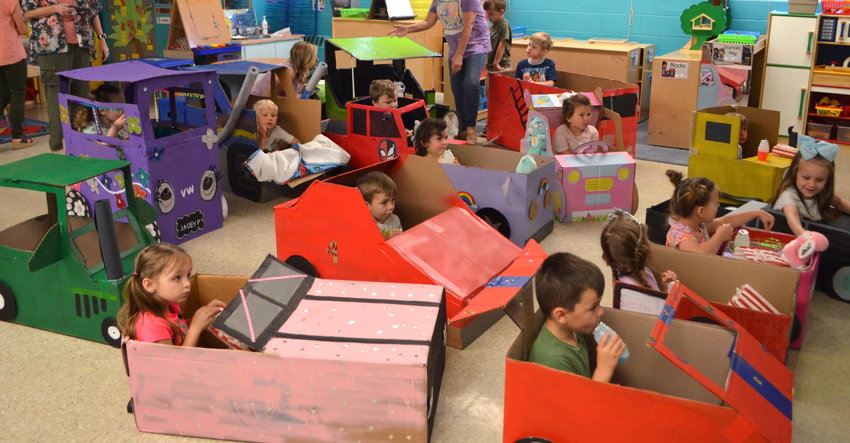 Pre-K students at Curry Elementary School crafted their own vehicles for a drive-in movie day at the school on Wednesday. The children relaxed in their cars, enjoyed popcorn and snacks, and watched an animated film. The cars were made as a family project between the children and their guardians. Pictured are students in Beth Bailey and Paige Harrod's Pre-K classrooms.