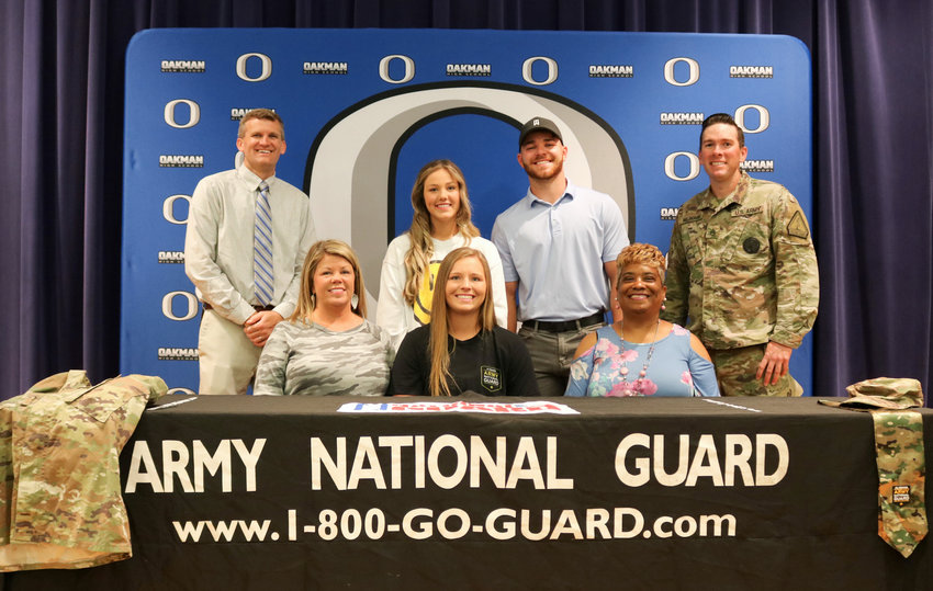 Oakman High School senior Carly Grace Woods, at center, signed with the Alabama Army National Guard on Monday.