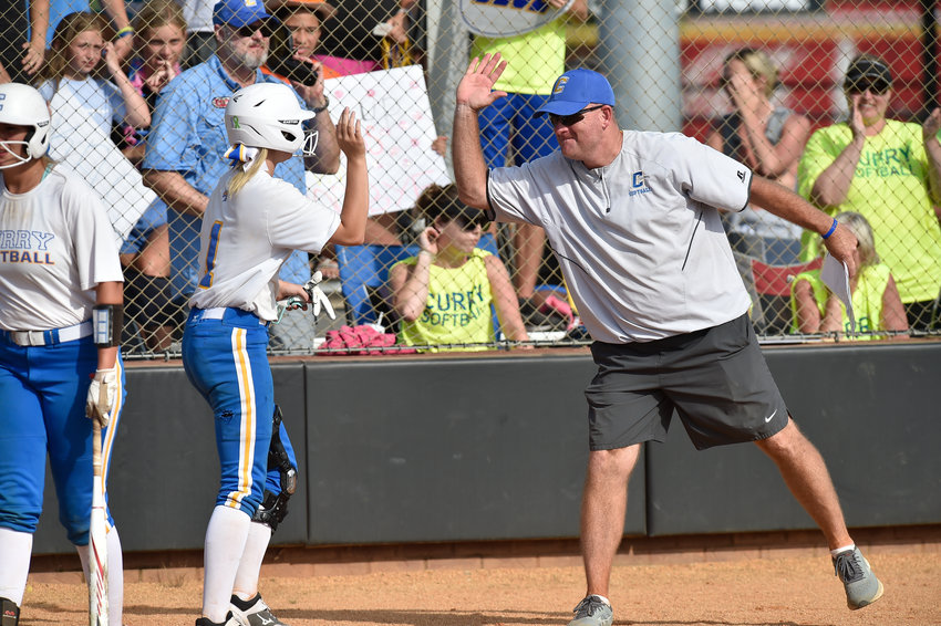 Curry coach Dave Lawson celebrates with Jenna Madison after she scored a run against Geneva during their game at the State Softball Tournament in Oxford on Thursday.