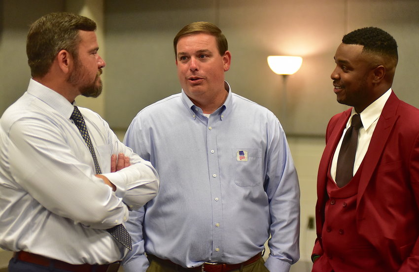 Matt Woods, center, who won the Republican primary for House District 13 without a runoff and with no Democratic opposition, holds a conversation at the Jasper Civic Center May 24. One of his opponents, Matt Dozier, left, and House District 14 candidate Cory Franks discuss the results as the votes were being counted.