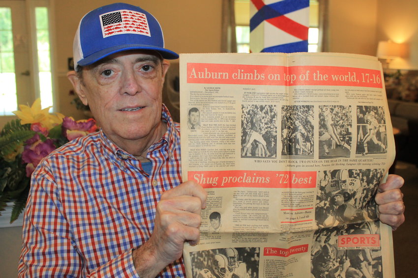 Wayne Hester holds up a December 1972 copy of The Anniston Star in which his byline appears. Hester, who was sports editor at both the Star and The Birmingham News, has been selected as one of 50 Legends of the Alabama Sports Writers Association.