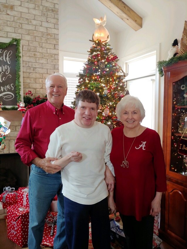 Garlin and Linda Farris celebrate Christmas with their son, Jeff. His mother has written a book on the lessons they have learned from raising and living with Jeff, who deals with cerebral palsy. A book signing will be held in Eldridge on Saturday, Aug. 20.