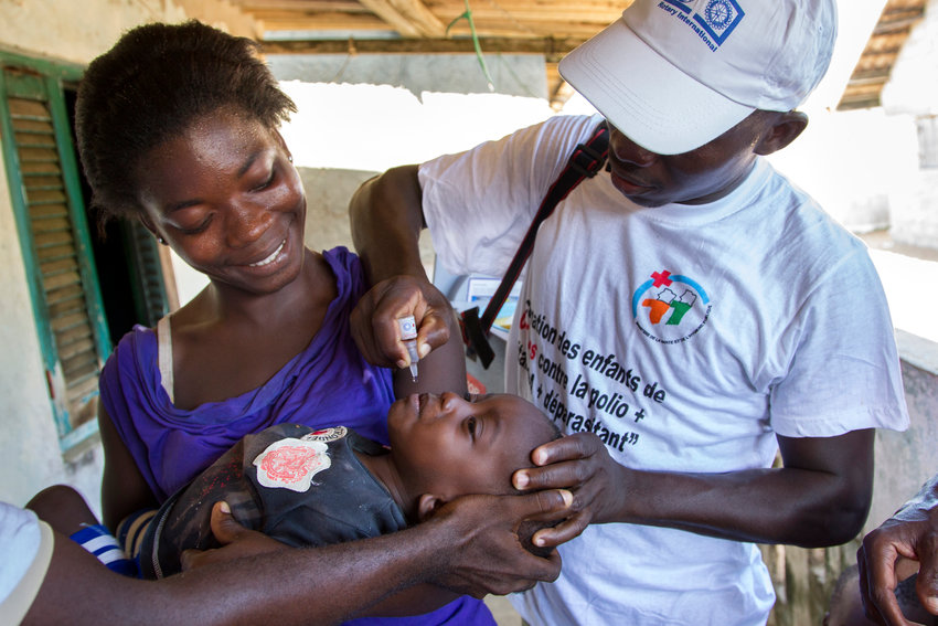 A healthcare worker administers polio vaccine to a child during a National Immunization Day in the village of Azuretti, Cote d'Ivoire in 2013. Rotary International's support of the fight to eradicate polio helped provide the vaccine.