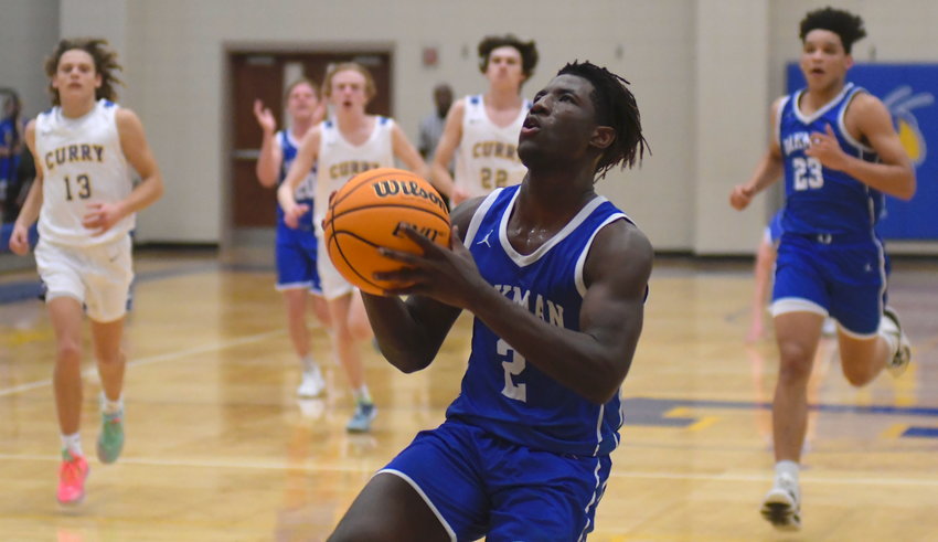 Oakman's Rick Johnson drives to the goal for a layup during Friday night's win at Curry.