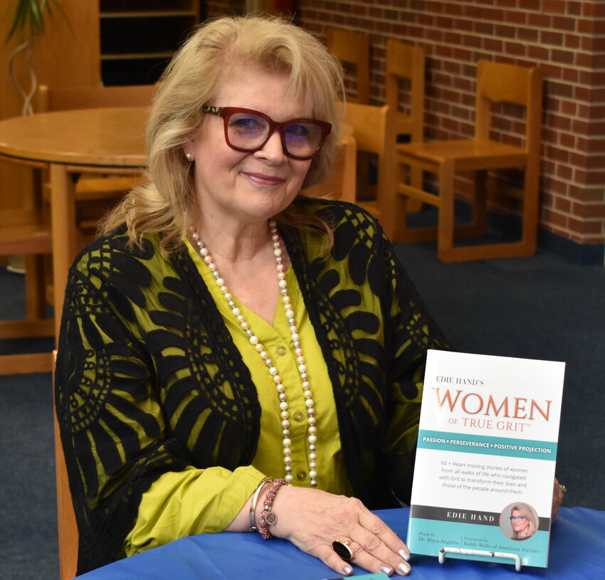 Author Edie Hand poses with her latest book, &quot;Edie Hand's Women of True Grit,&quot; which tells the success stories of more than 60 women. She was featured at a Women's History Month event at Bevill State Community College in Sumiton on Wednesday.