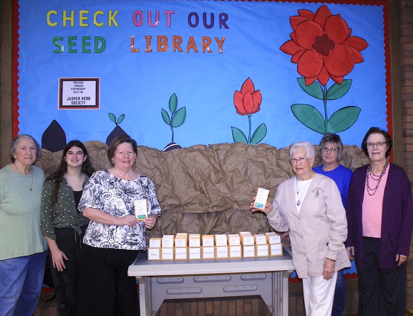 Members of the Jasper Herb Society and employees with the Carl Elliott Regional Library are pictured at the new seed library.