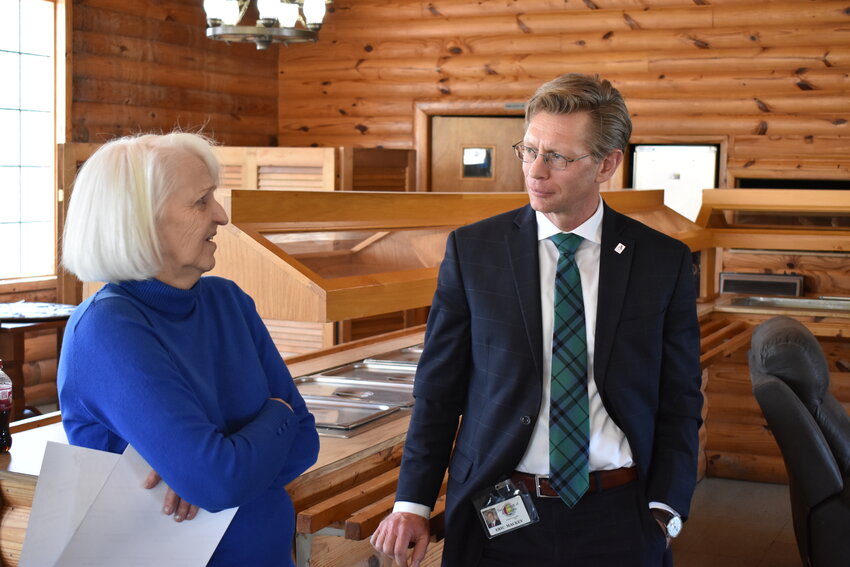 Theresa Snoddy, left, speaks with state Superintendent of Education Eric Mackey inside one of the buildings on the Looney's Tavern entertainment complex near Double Springs on March 13.