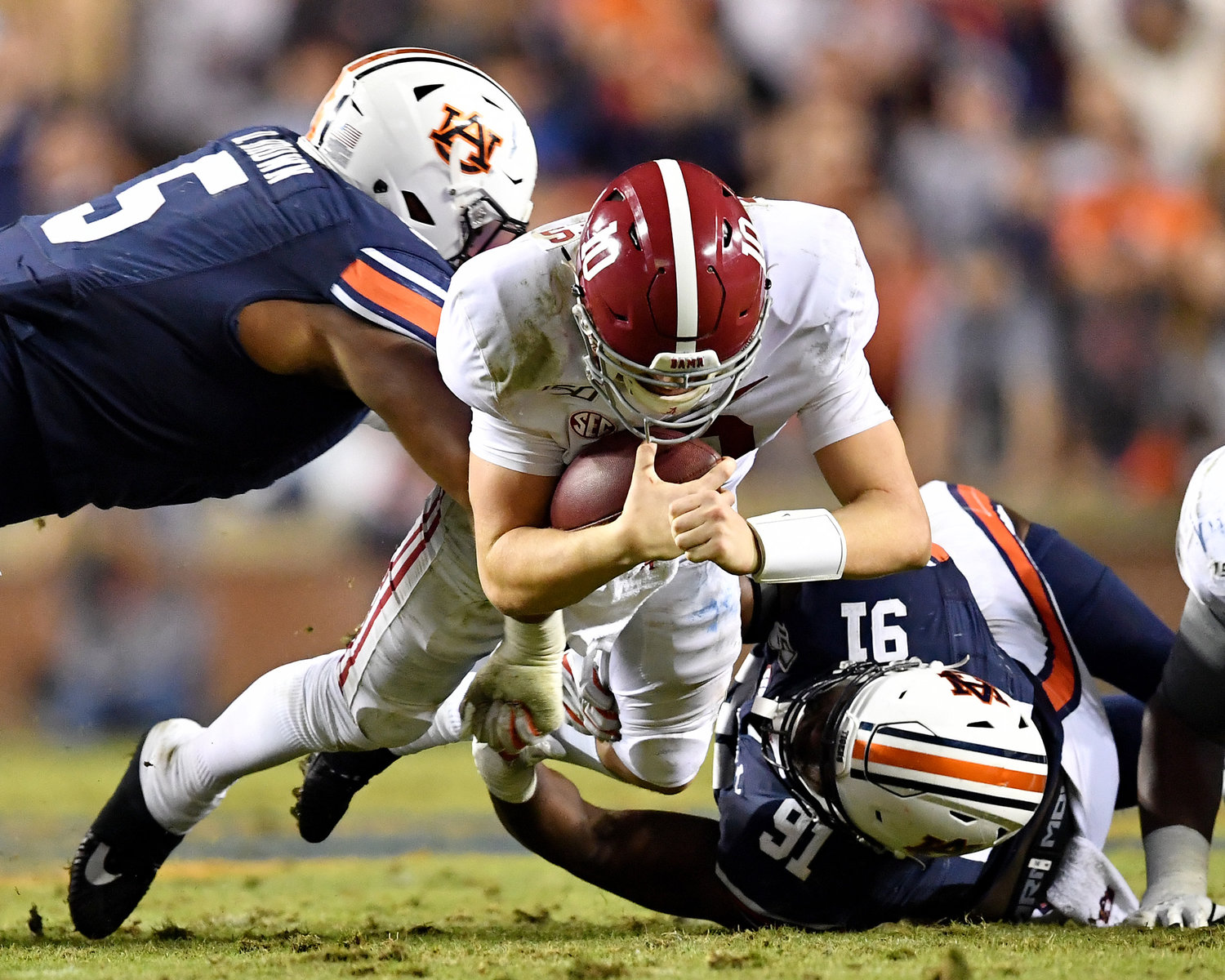 Alabama Crimson Tide quarterback Mac Jones (10) is tackled as he tries to get a first down during the second half of an NCAA football game against the Auburn Tigers Saturday, Nov. 30, 2019, at Jordan-Hare Stadium in Auburn, Ala.