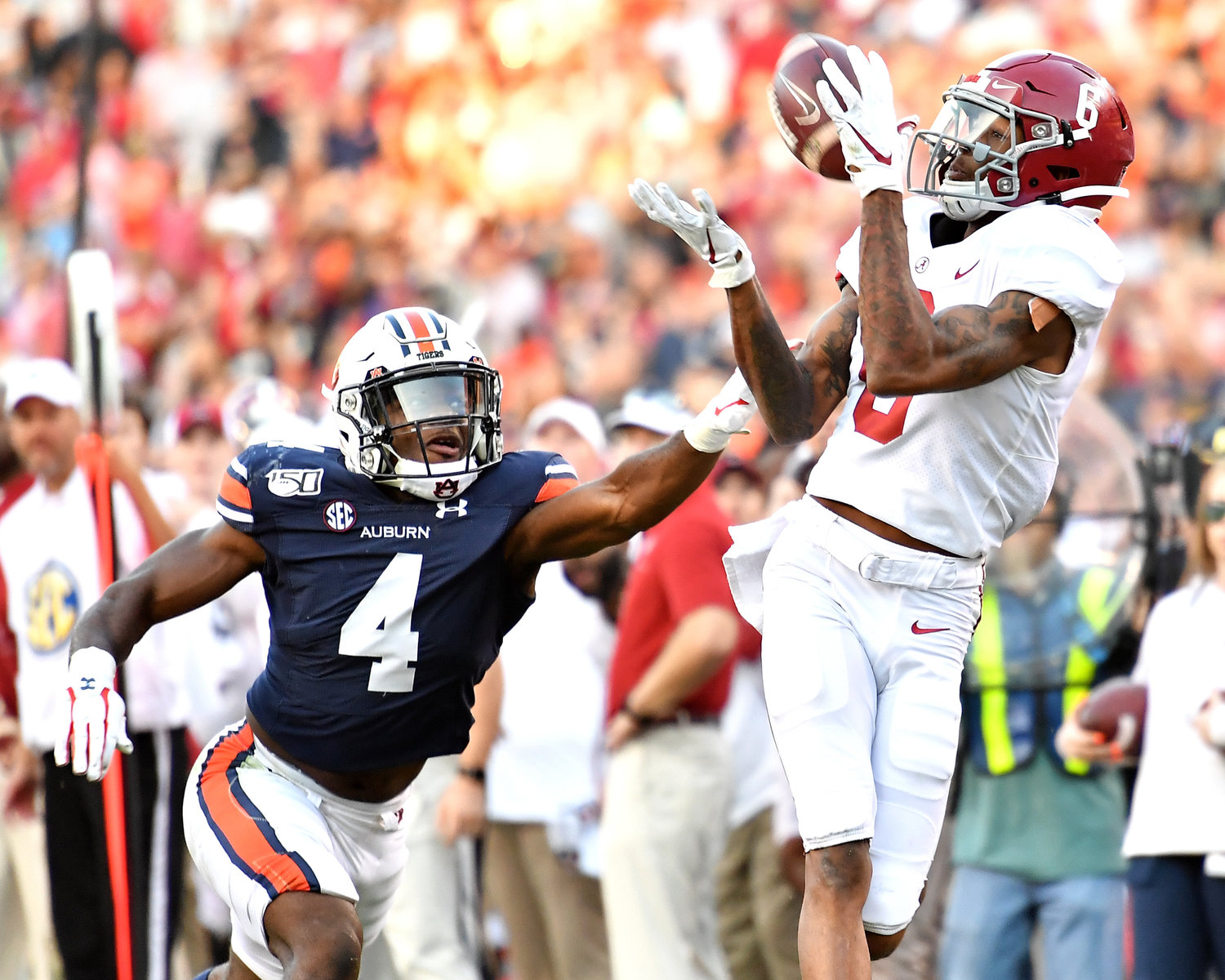 Alabama Crimson Tide wide receiver DeVonta Smith (6) makes a big catch for a first down late in the second quarter of an NCAA football game against the Auburn Tigers Saturday, Nov. 30, 2019, at Jordan-Hare Stadium in Auburn, Ala.