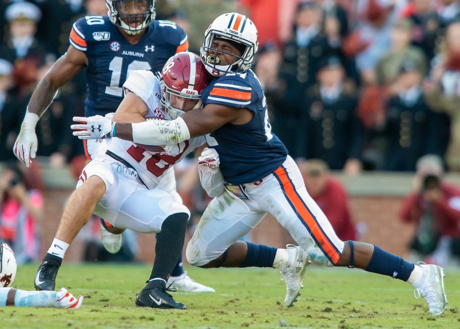 Alabama Crimson Tide wide receiver Slade Bolden (18) is tackled by Auburn Tigers defensive back Daniel Thomas (24) during the first half of Saturday's game, at Jordan-Hare Stadium in Auburn, AL. Daily Mountain Eagle -  Jeff Johnsey
