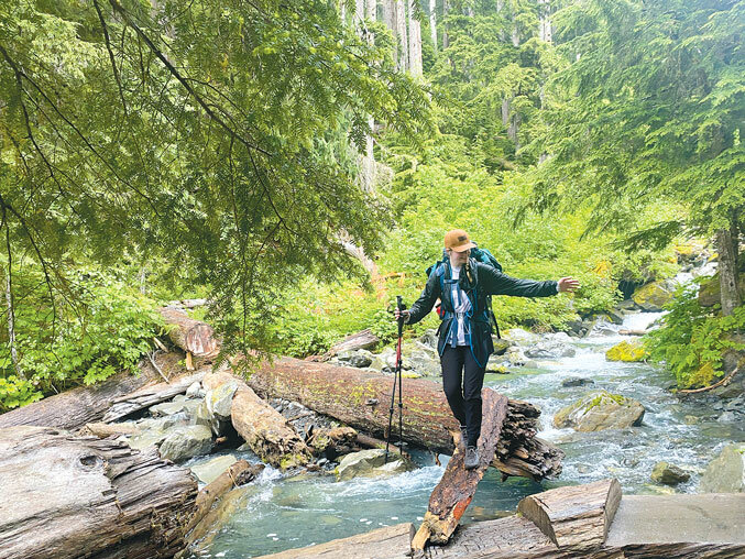 Maddie balances on a thin log while crossing a creek about a mile from camp on day one.
