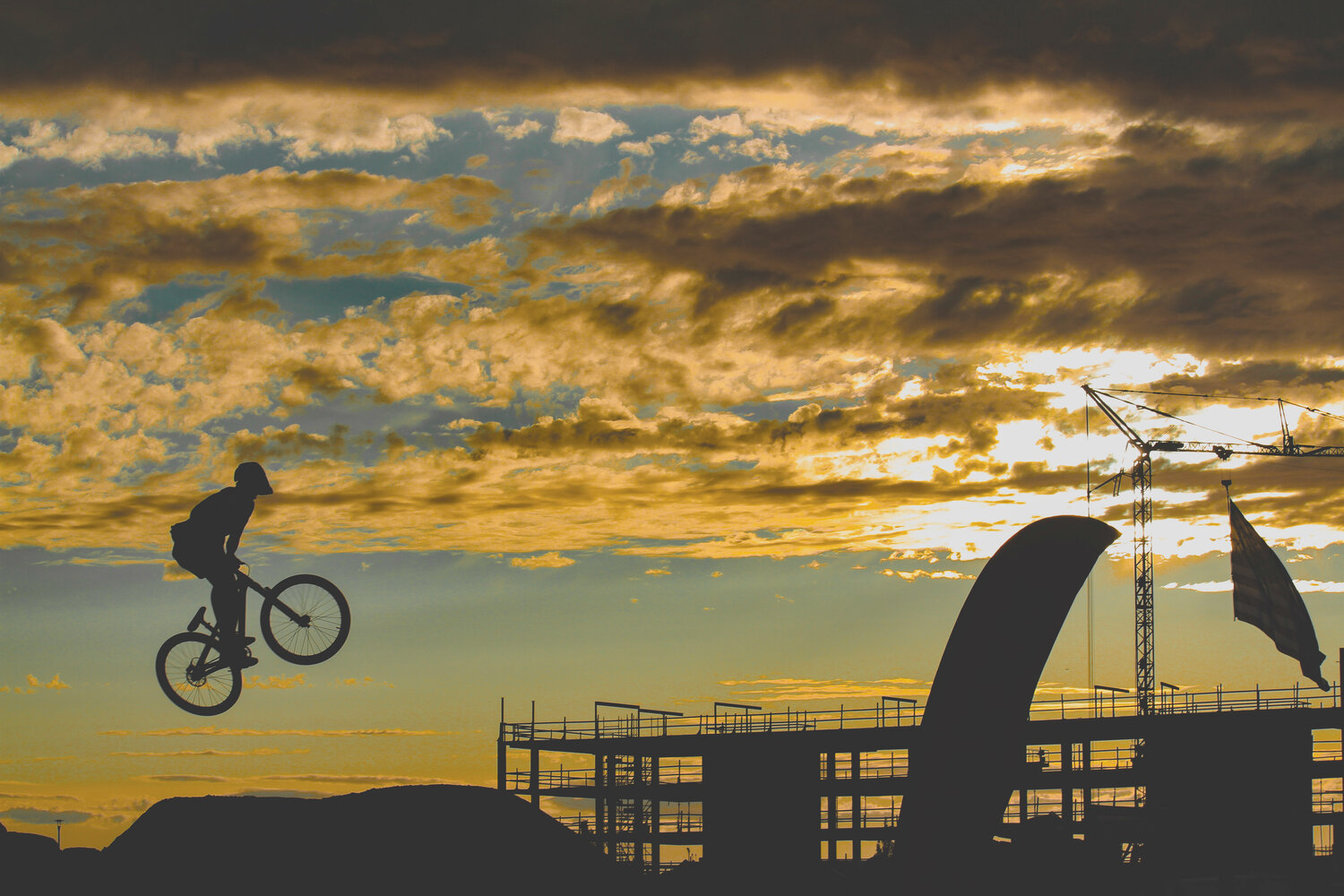 A mountain biker rises above the horizon during the 2023 Northwest Tune-Up festival on Bellingham's waterfront district.
