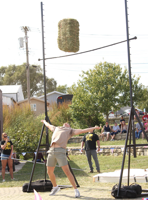 Here you can see Clay Schmidt trying to throw his bail of hay over the bar as onlookers watched.