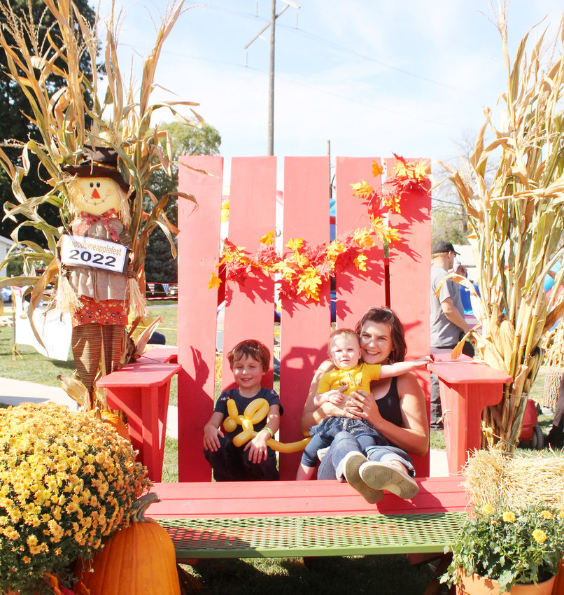 Liam, Zayla, and Shari Sauter enjoyed one of the Applefest staples, the big lawn chair.