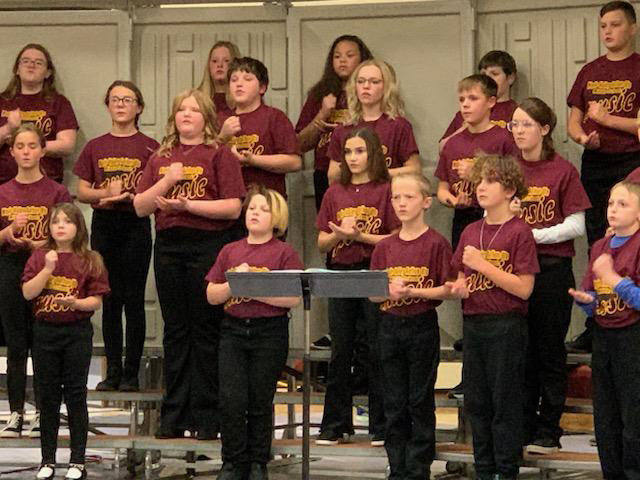 The sixth grade chorus sang "Just Be Happy," "Rock, Paper, Scissors," and "Ten Songs of America."