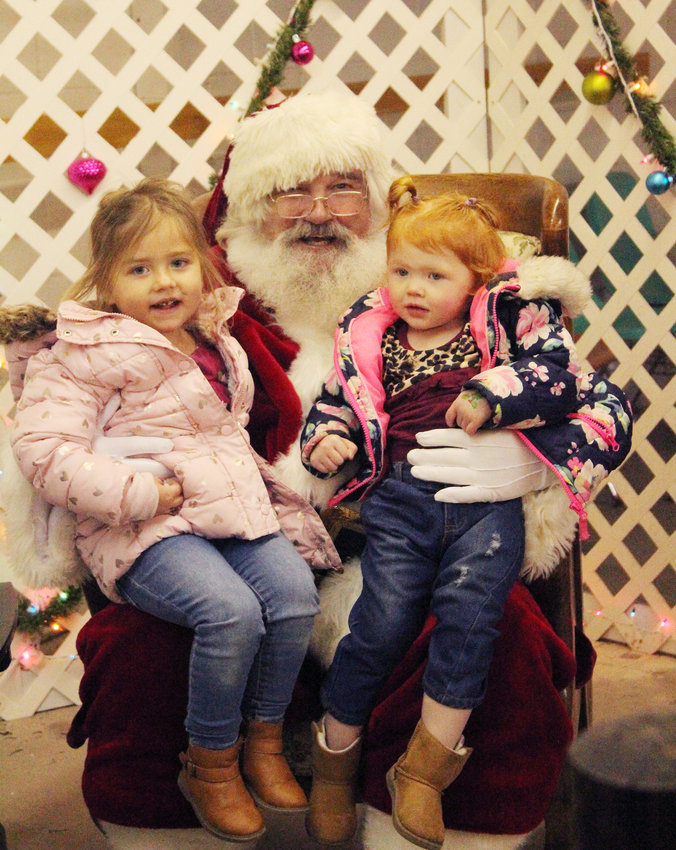 The big man himself was even at the fairgrounds in Missouri Valley over the weekend. Here Amelia and Delia Hinkel enjoy giving Santa hugs and telling him what they wish for this Christmas.