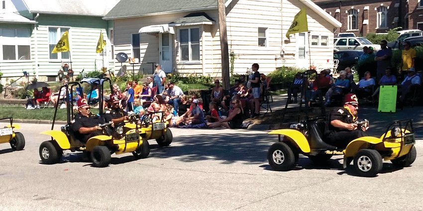 The Shriners drive their yellow cars through the Harrison County Fair Parade.