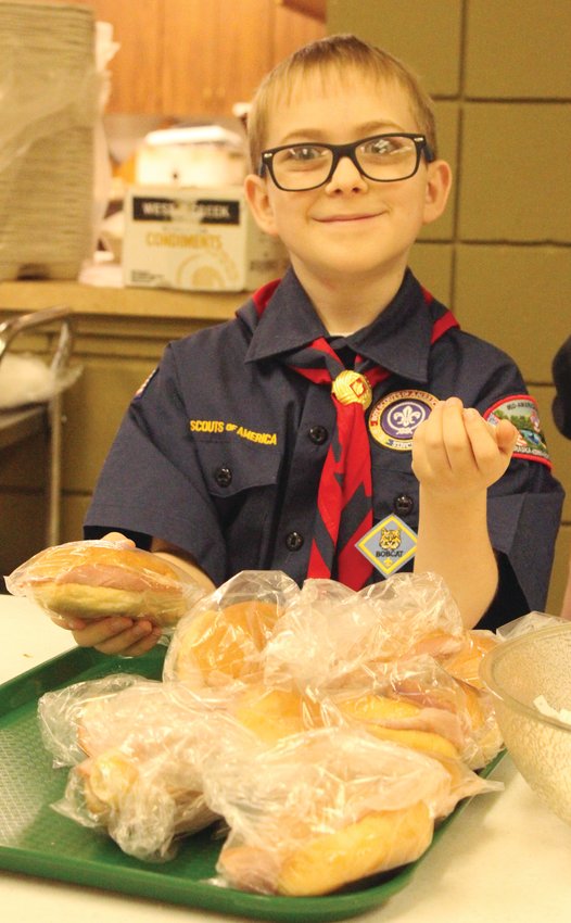 David Brady served sandwiches with a smile during the Cub Scout Soup Supper.