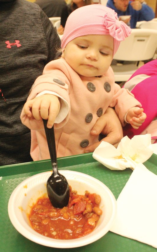 Little Carianne Beckner approved of the chili that was served at the Cub Scouts Soup Supper held over the weekend.