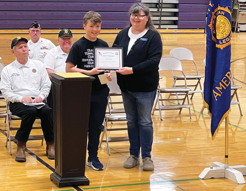 Charlie Follman is presented with his award by American Legion Post 224 Commander Jen Miller. Follman is the son of Amanda and Ryan Stinn.