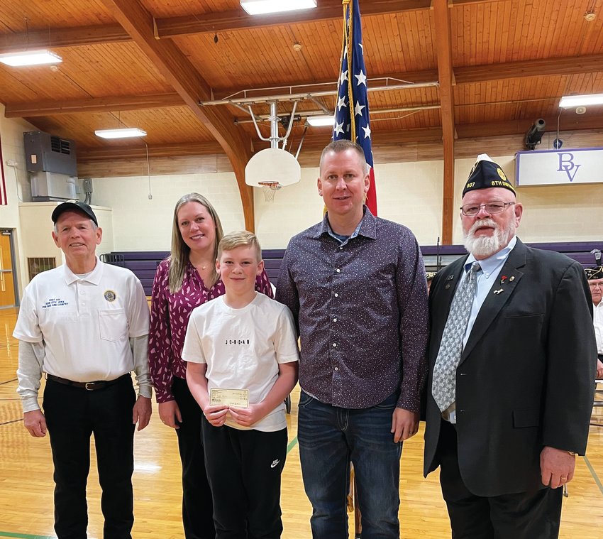 Lane Martins (middle) poses with his check alongside (from left) American Legion Post 444 Commander Doyle Siglin, his mother Jeni Martins, father Mike Martins, and a representative from the American Legion 8th District.