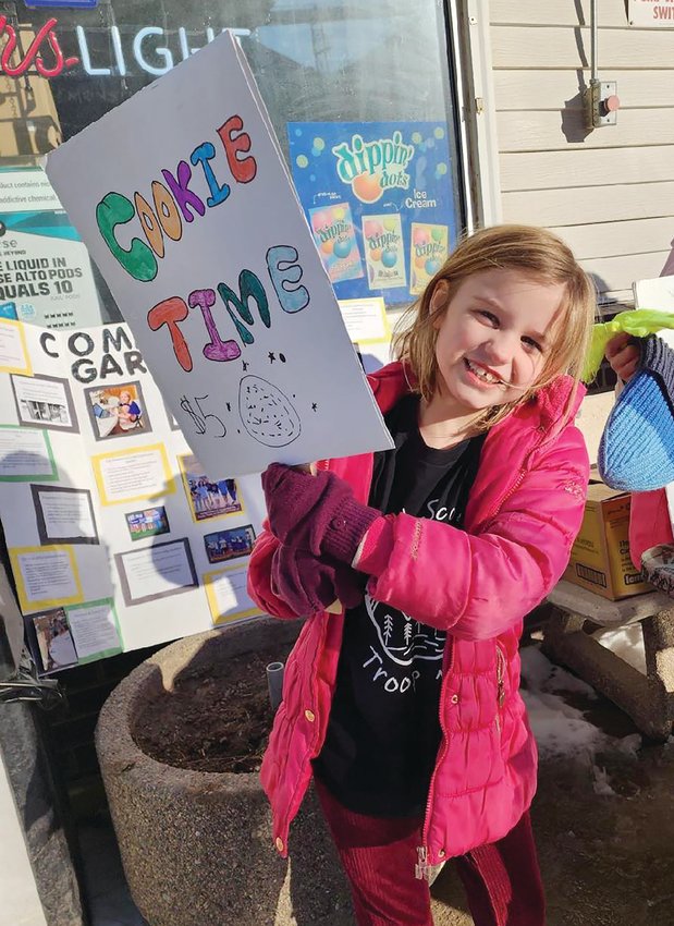 Claire Meyer decided it was “Cookie Time!” as she held a homemade sign during the Girl Scout Troop 163 of Boyer Valley’s cookie fundraiser.