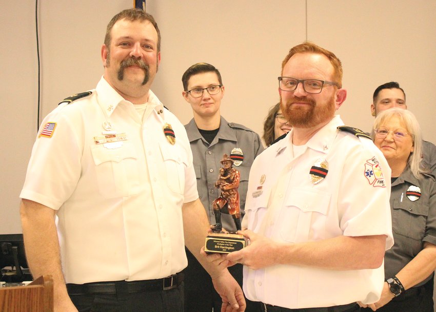 Caleb Wohlers presented the "Firefighter of the Year" award to Brit Harrington.