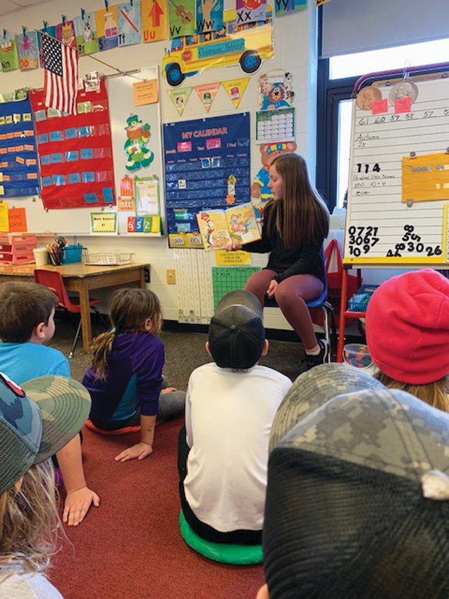 High school guest reader, Zoey Soma, read a Dr. Seuss book to Mrs. Branning's first grade students.