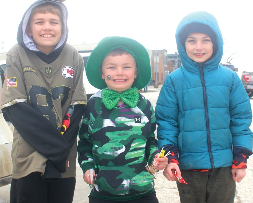 Colton, Nolan and Henry Muff tried to stay warm during the St. Patricks Day Parade in Dunlap.