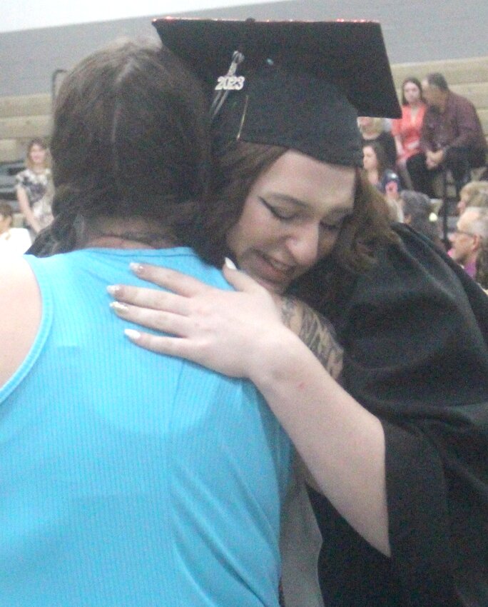 West Harrison's Kierstyn Bieler hugs her mother during the rose presentation at the West Harrison High School graduation ceremony on May 14 in Mondamin.