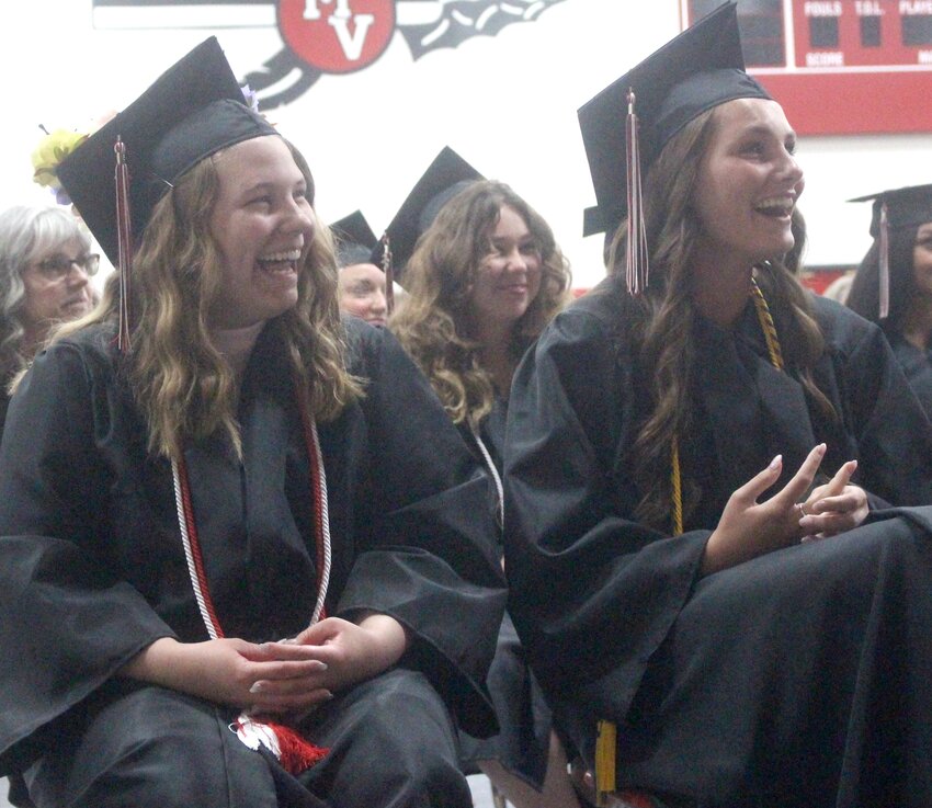 Missouri Valley's Madelynn Harper and Emma Gute enjoy a laugh during the school memories portion of the 2023 High School graduation ceremony on May 13.