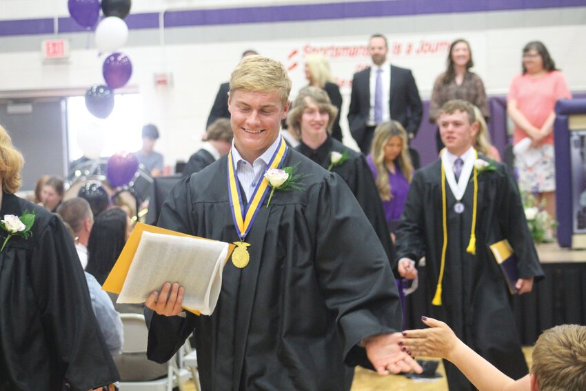 Bobby Gross executes a well-earned high five at the end of Sunday's commencement exercises.