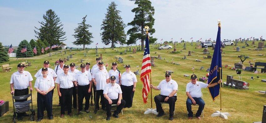 A Memorial Day presentation was held at the Dow City Cemetery and put together by American Legion Post #444. Pictured left to right in the back row: Jim Polzin, Rollie Roberts, Steve Hartmann, Jack Ahart, Jessie Sharp, Paul Laubsher. Pictured left to right in the front row: Gary Thomson, Doyle Siglin, Donavon Merritt, Chuck Ten Eyck, Lisa Parrott, Carolyn Starkwether. Seated: Andy Reister. Seated next to flags: American flag, Bob Ettleman; American Legion flag, Louie Claire "Doc" Ahart.