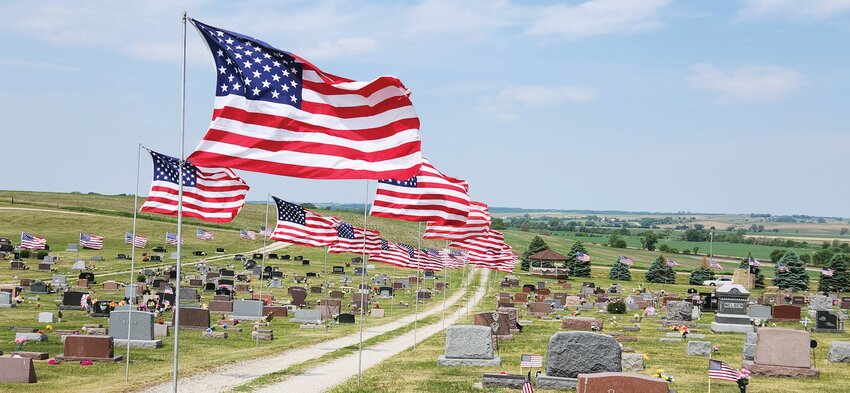 The flags swayed in the breeze on a solemn day of remembrance at the Dow City Cemetery on Monday.