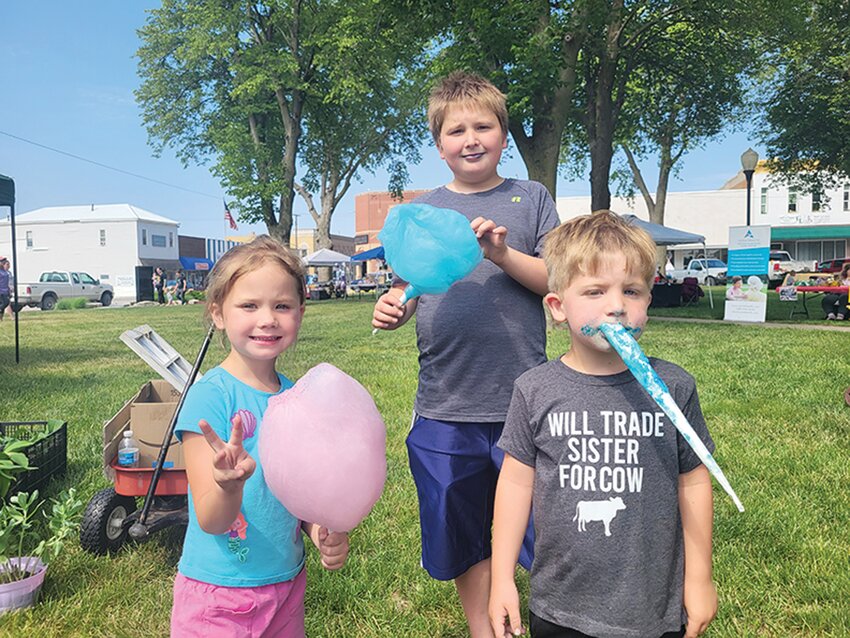 Siblings Lonnie, Conrad and Lane Thacker enjoyed a sweet treat over the weekend in Logan at the annual Village on the Green Event.