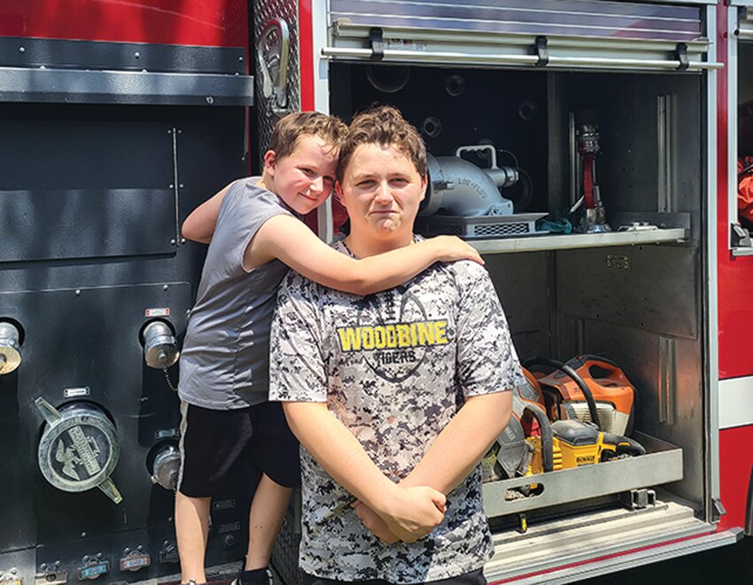 In addition to fire truck rides on a classic fire truck, the Logan Fire and Rescue Association also gave community members the chance to get an up-close look at current fire and rescue vehicles. Here Robert Luster and Joshua Luster can be seen enjoying the trucks.