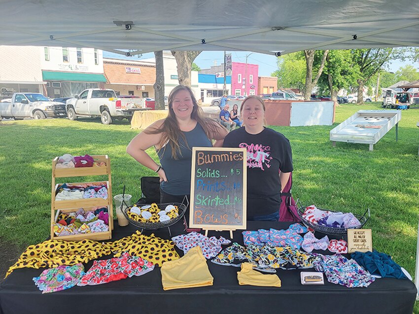 Local “Blonde Mom Boutique” owners Kieran Barnum and Lexi Rider enjoyed having the chance to visit with locals and sell handmade goods at this years Village on the Green event in Logan.