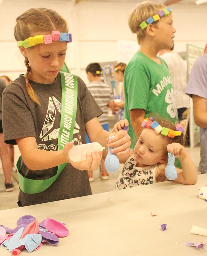Children enjoyed gathering to make crafts in the 4H building at this year’s fair during the working exhibit demonstrations.