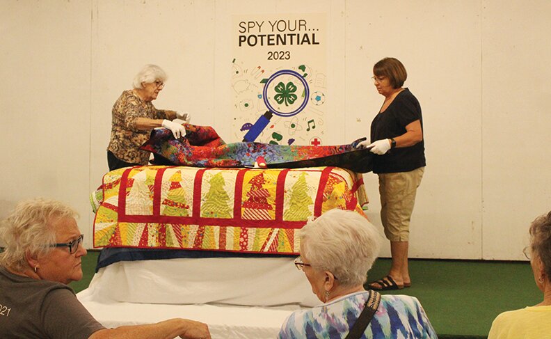The annual quilt turning event was held in the 4H building during the Harrison County Fair.